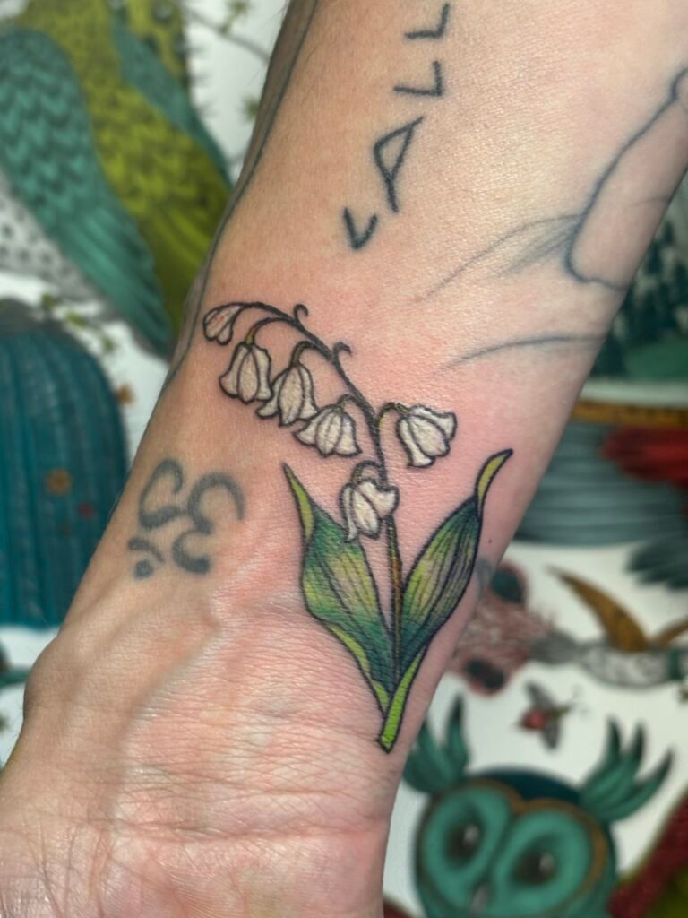 Lily of the Valley color tattoo on wrist