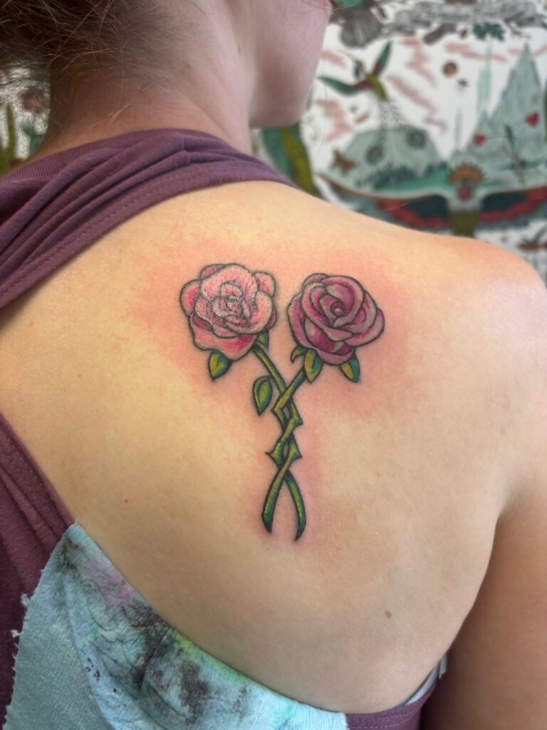 American Traditional rose tattoo on shoulder colored pink roses